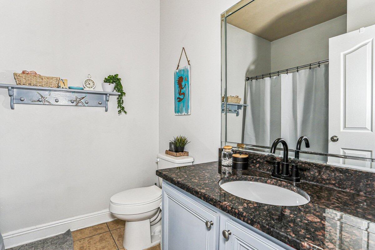 405 Pendo Place Crestview, FL 32536 - Photo 27 of 39 a bathroom with a granite countertop sink a toilet and a mirror