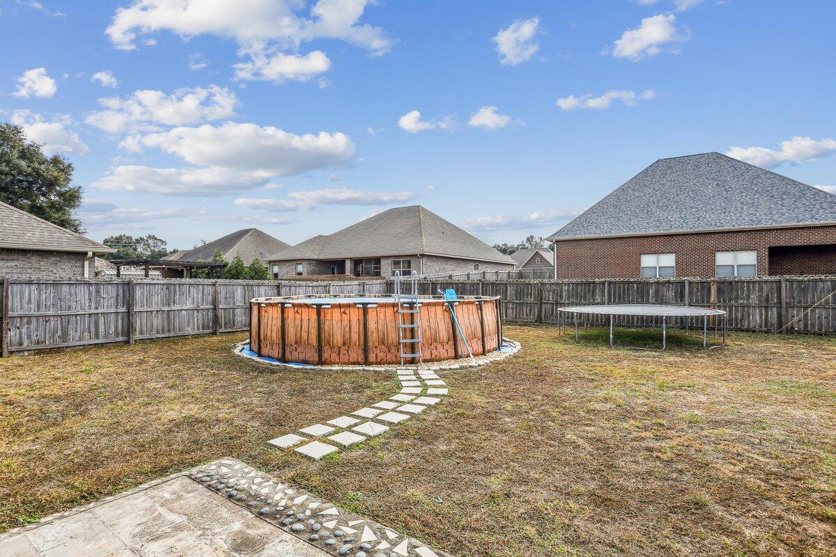405 Pendo Place Crestview, FL 32536 - Photo 38 of 39 a view of swimming pool with table and chairs under an umbrella