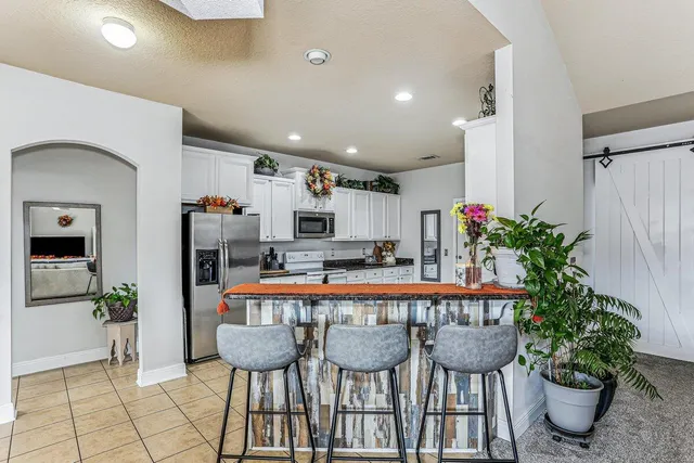 a dining room with furniture and a potted plant