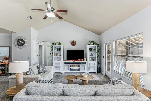 a living room with furniture and a flat screen tv