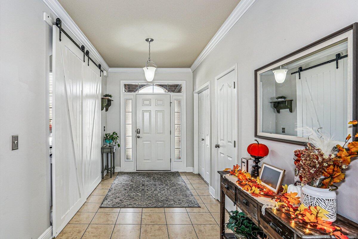 405 Pendo Place Crestview, FL 32536 - Photo 10 of 39 a entryway with furniture and a chandelier