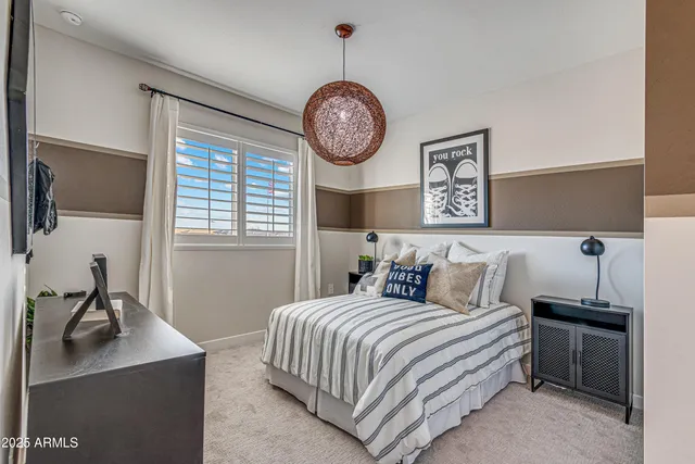 a bedroom with a bed and a chandelier