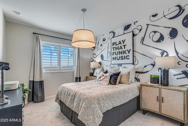 a bedroom with a bed and a chandelier