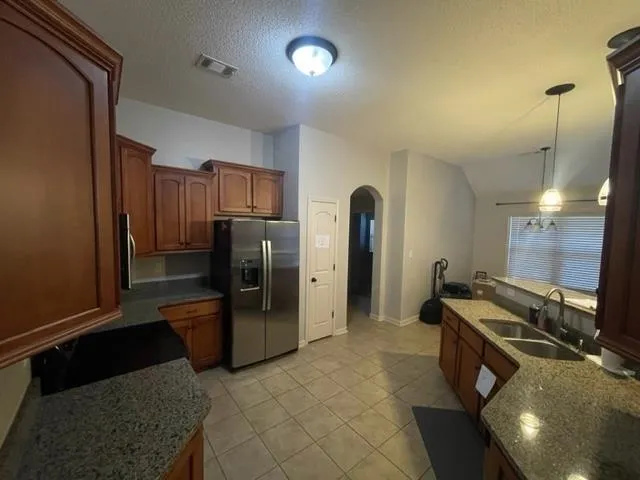 a view of a kitchen with a sink granite top and living room