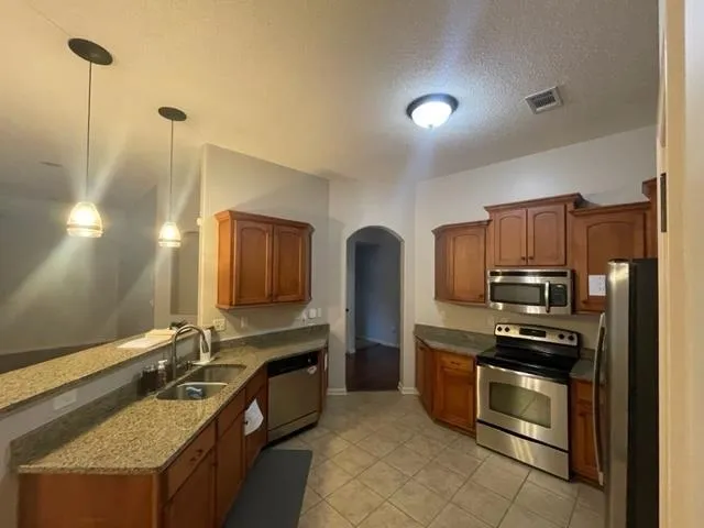 a kitchen with refrigerator and table