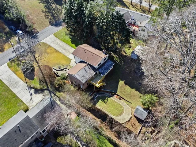 an aerial view of a houses with yard