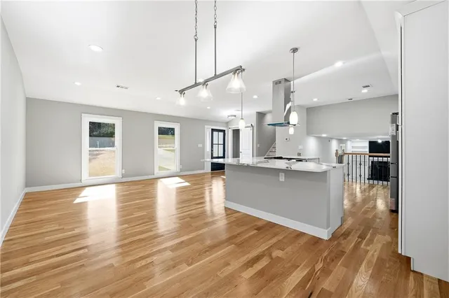 a view of kitchen with kitchen island and stainless steel appliances