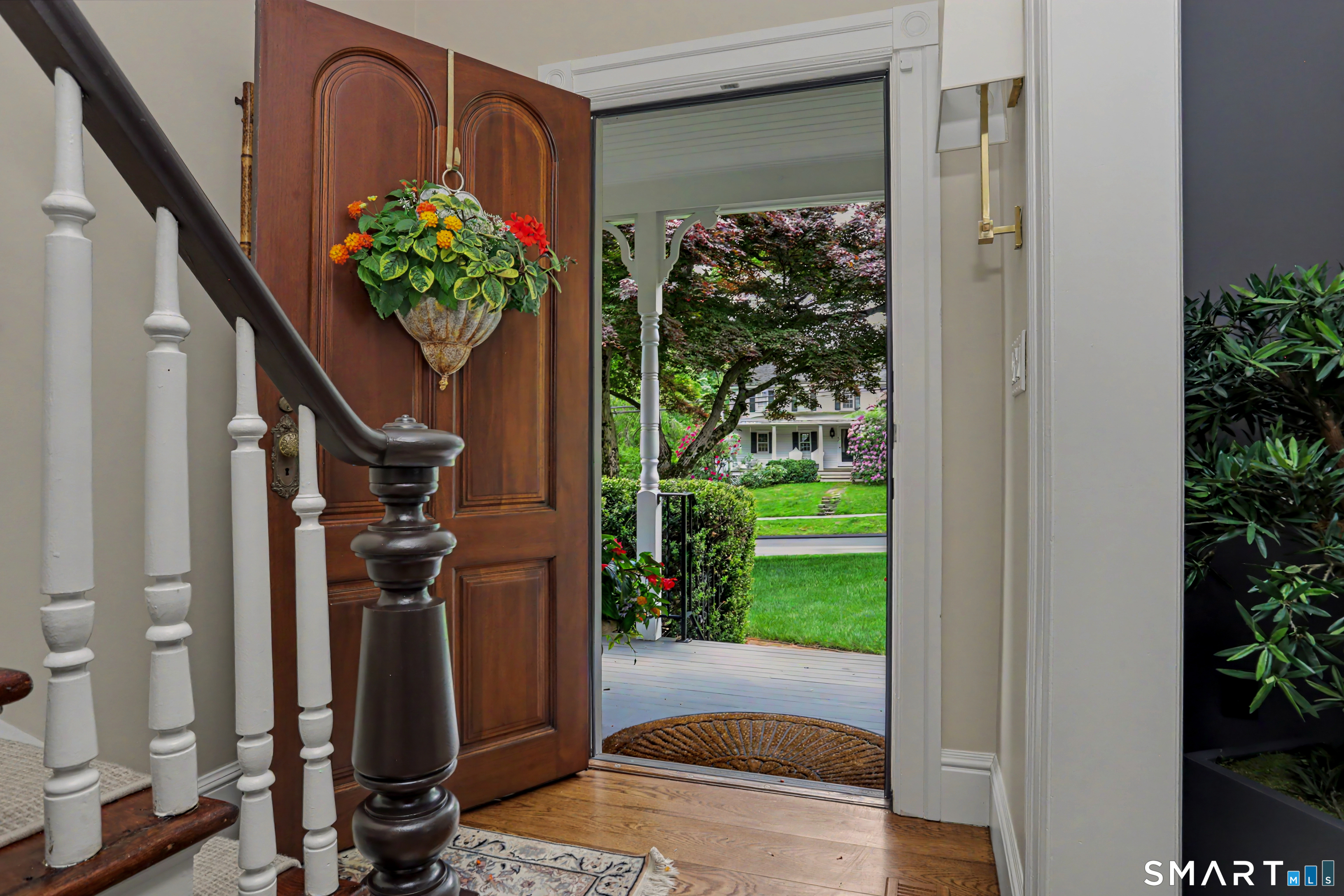 36 Catoonah Street, Unit 18 Ridgefield, CT 06877 - Photo 6 of 40 a vase with flowers sitting on a floor in front of a door