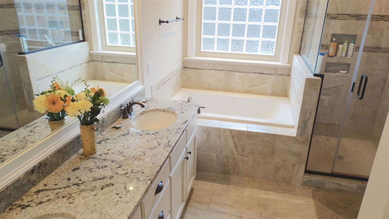1308 Trinity Circle Raleigh, NC 27607 - Photo 11 of 25 Base-height vanities with Double Bowls leading to a deep soaking tub and separate Custom-Tiled Shower await you! Turn the corner and enter your Luxurious Walk-In Closet! Master Bath/Spa