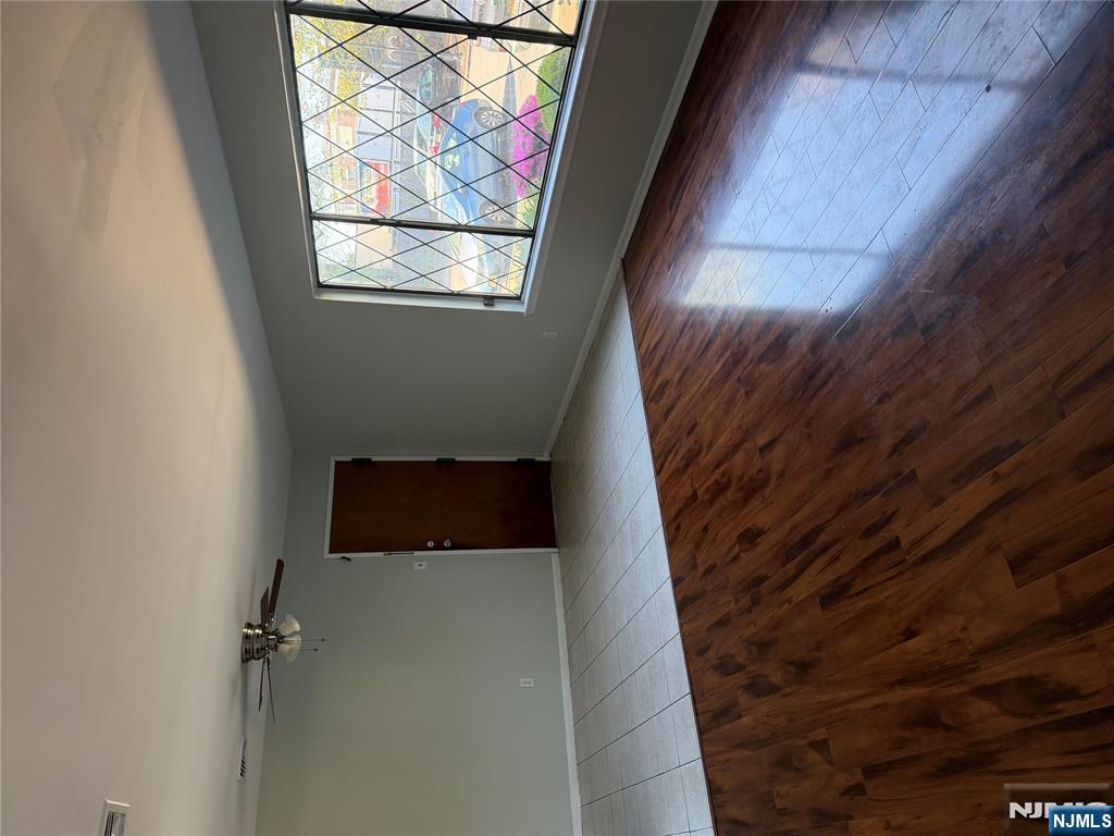 192 Burnett Avenue Maplewood, NJ 07040 - Photo 3 of 13 an empty room with wooden floor and windows