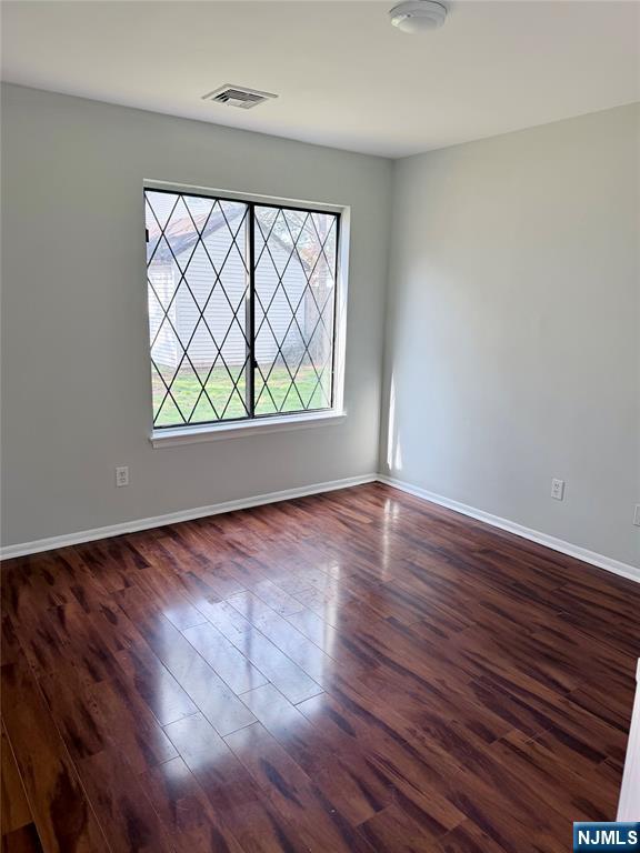 192 Burnett Avenue Maplewood, NJ 07040 - Photo 4 of 13 an empty room with wooden floor and windows
