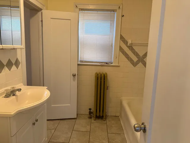a bathroom with a sink a mirror and a shower