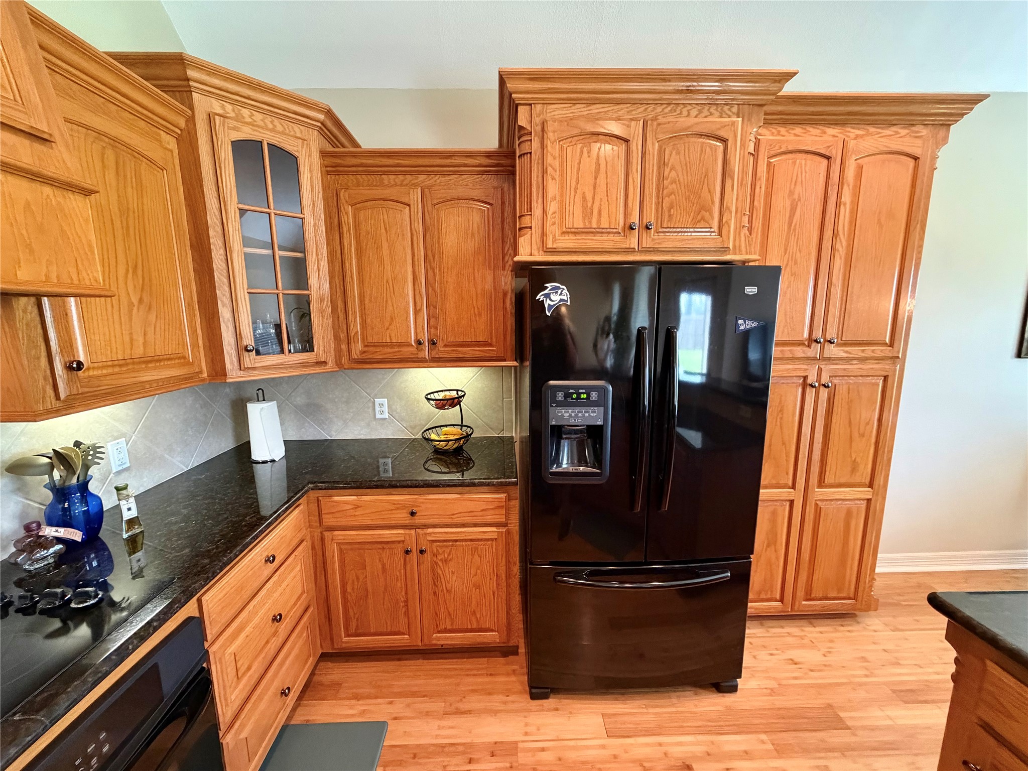 1448 South Blue Bonnet Lane Angleton, TX 77515 - Photo 12 of 43 a kitchen with stainless steel appliances granite countertop a refrigerator and a stove