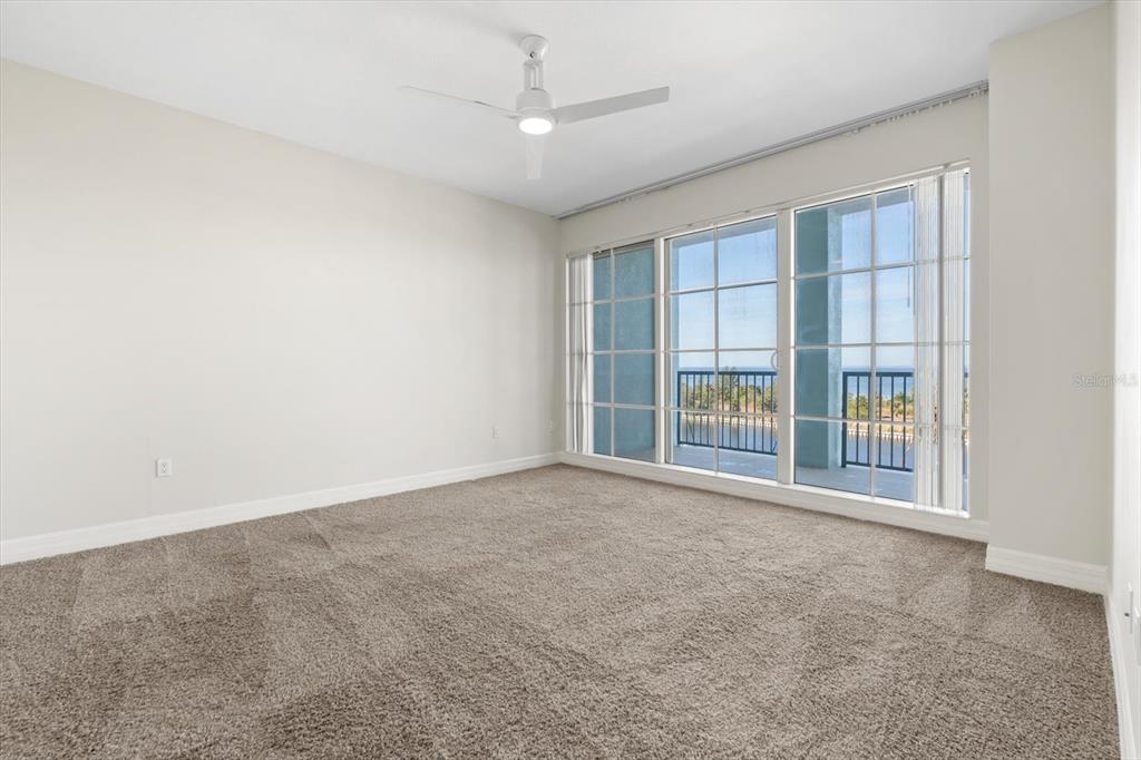 536 Bahia Beach Boulevard, Unit 428C Ruskin, FL 33570 - Photo 13 of 30 an empty room with a fireplace and large window