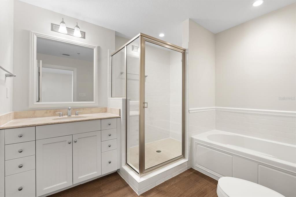 536 Bahia Beach Boulevard, Unit 428C Ruskin, FL 33570 - Photo 16 of 30 a bathroom with a granite countertop sink a toilet and bathtub