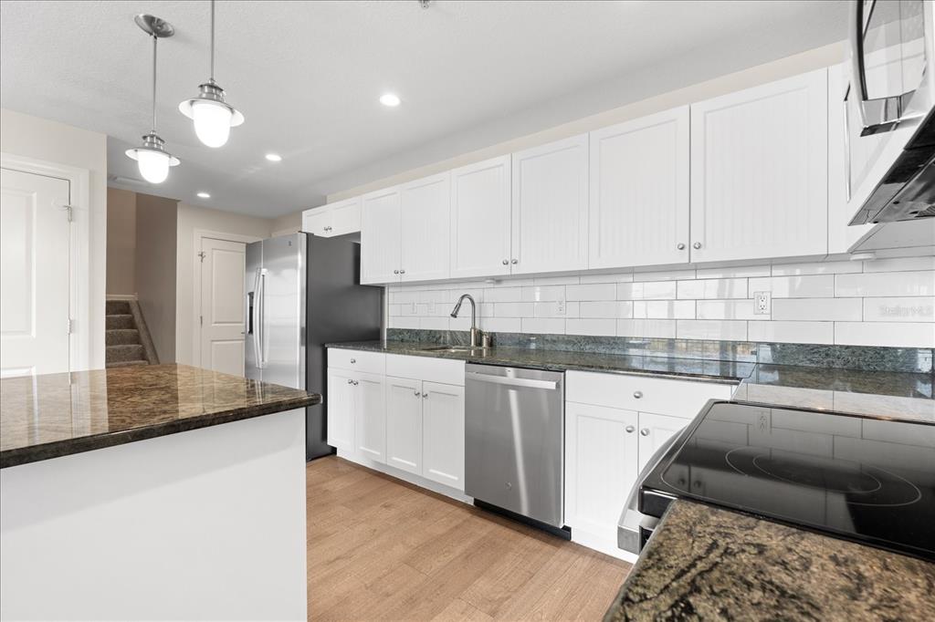 536 Bahia Beach Boulevard, Unit 428C Ruskin, FL 33570 - Photo 3 of 30 a kitchen with stainless steel appliances granite countertop a sink a stove and a refrigerator