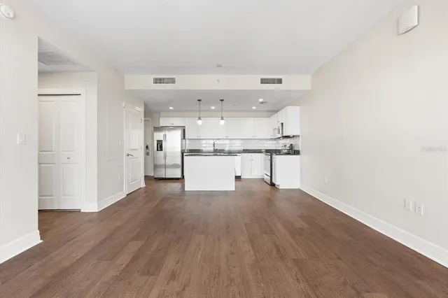 a big room with wooden floor and windows