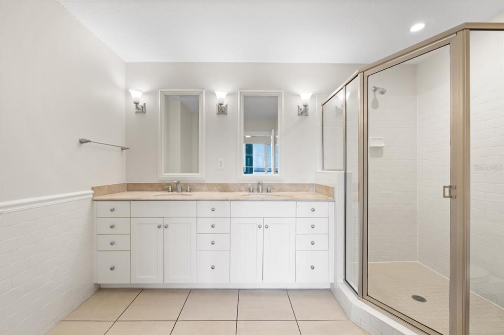 536 Bahia Beach Boulevard, Unit 428C Ruskin, FL 33570 - Photo 10 of 30 a bathroom with a granite countertop sink a mirror and a shower