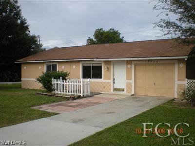 17160 Lee Road Fort Myers, FL 33967 - Photo 1 of 10 front view of a house with a yard