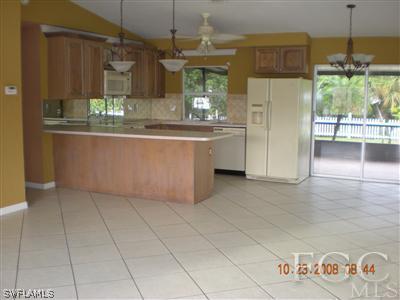 17160 Lee Road Fort Myers, FL 33967 - Photo 4 of 10 a kitchen with stainless steel appliances granite countertop a refrigerator and a stove top oven