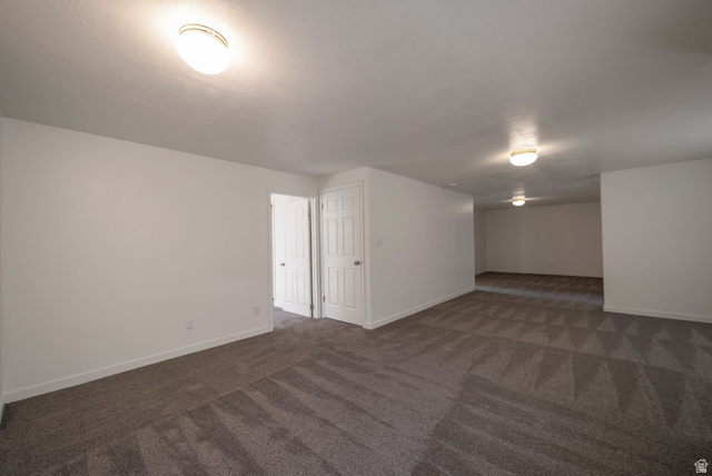 11922 Bluff View Drive Sandy, UT 84092 - Photo 17 of 30 Bonus room featuring baseboards and dark colored carpet