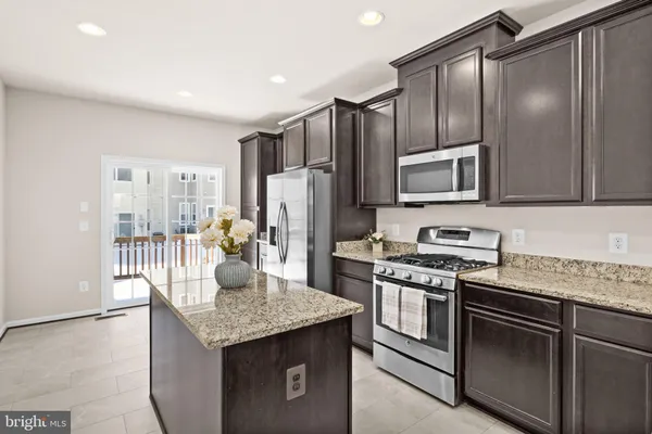 a kitchen with a refrigerator and a sink