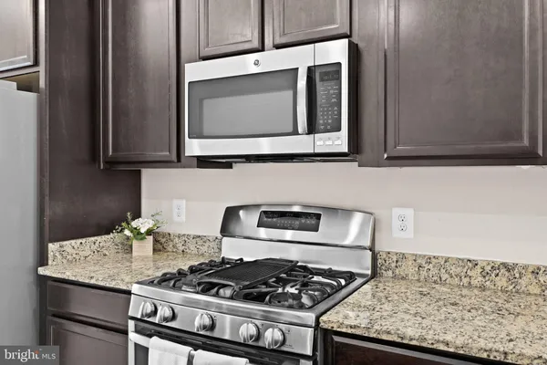 a metallic refrigerator freezer and a refrigerator in a kitchen