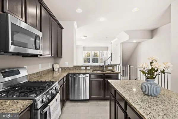a kitchen with a refrigerator sink and stove
