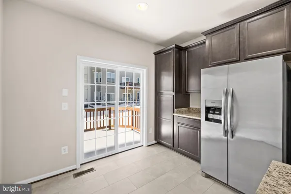 a kitchen with stainless steel appliances granite countertop a refrigerator a sink and a stove