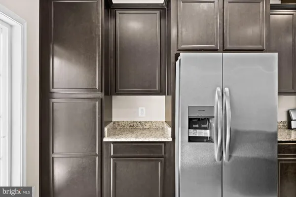 a kitchen with a stove a sink and a refrigerator