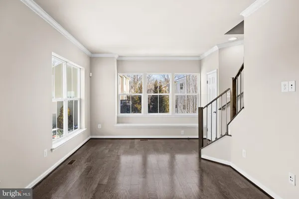 a view of an empty room and stairs