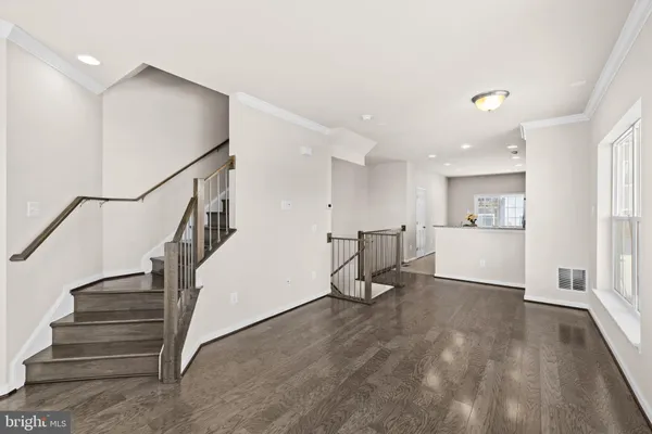 an empty room with a ceiling fan and a fan