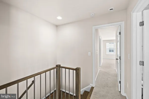 a bedroom with a balcony a bed and a painting on the wall