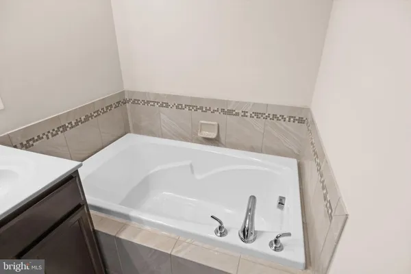 a bathroom with a sink vanity and a mirror