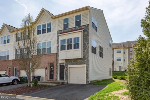 a view of staircase with wooden floor and white walls