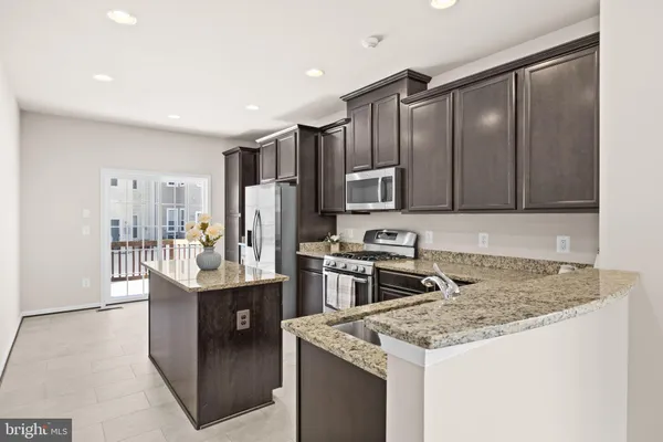 a kitchen with granite countertop stainless steel appliances and cabinets