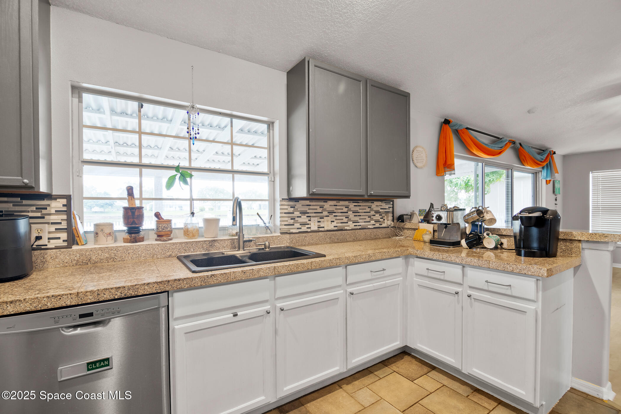 443 Wenthrop Circle Rockledge, FL 32955 - Photo 15 of 38 a kitchen with stainless steel appliances granite countertop a sink a stove and cabinets