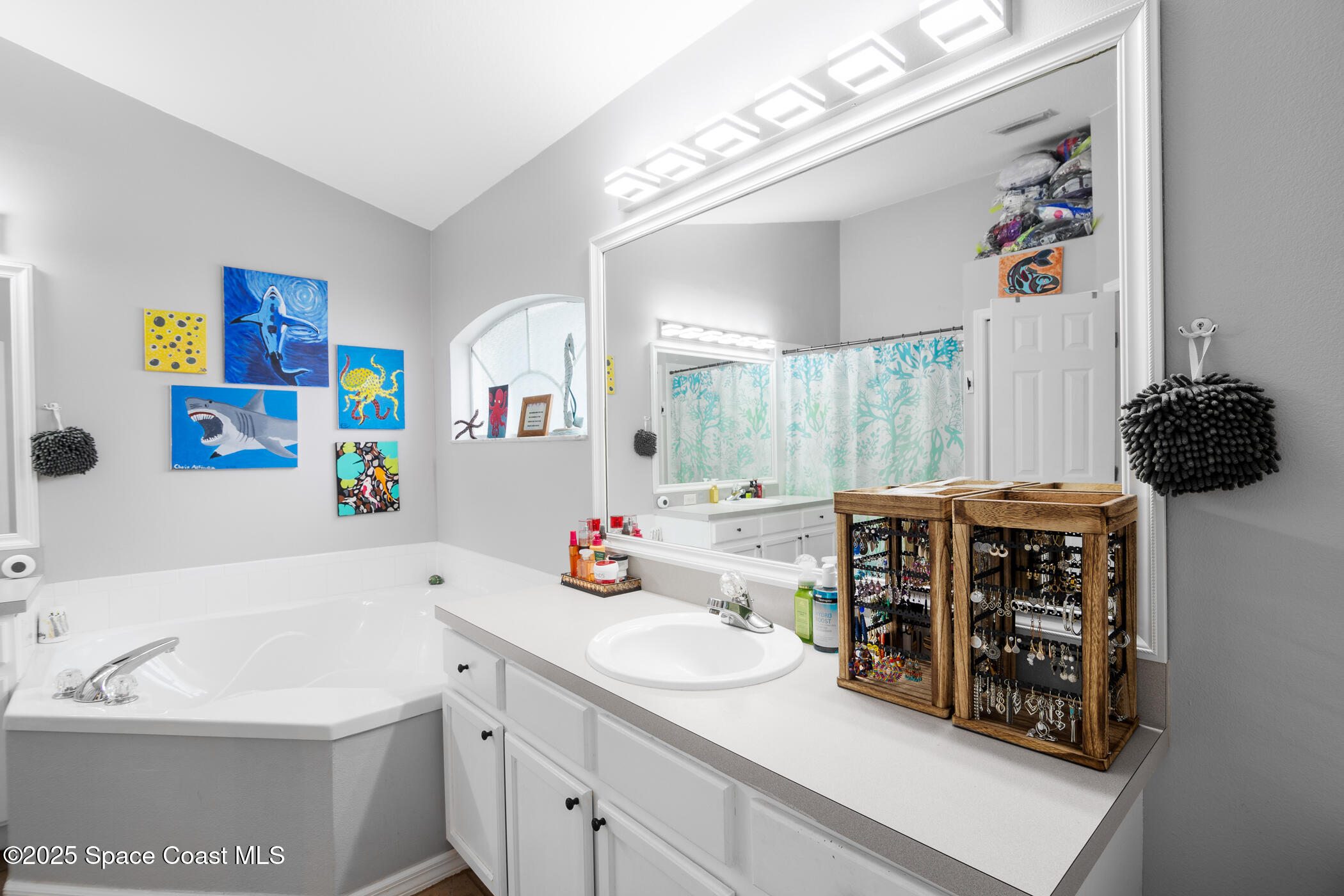 443 Wenthrop Circle Rockledge, FL 32955 - Photo 17 of 38 a bathroom with a sink a large mirror and a shower