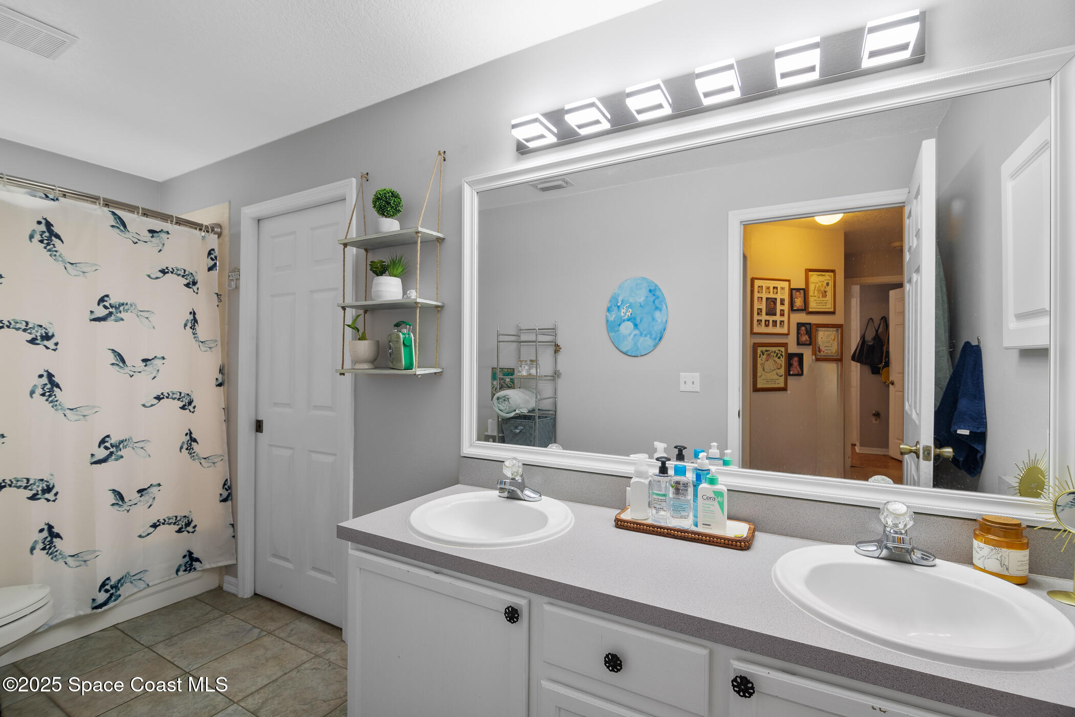 443 Wenthrop Circle Rockledge, FL 32955 - Photo 22 of 38 a bathroom with a sink a vanity and a mirror