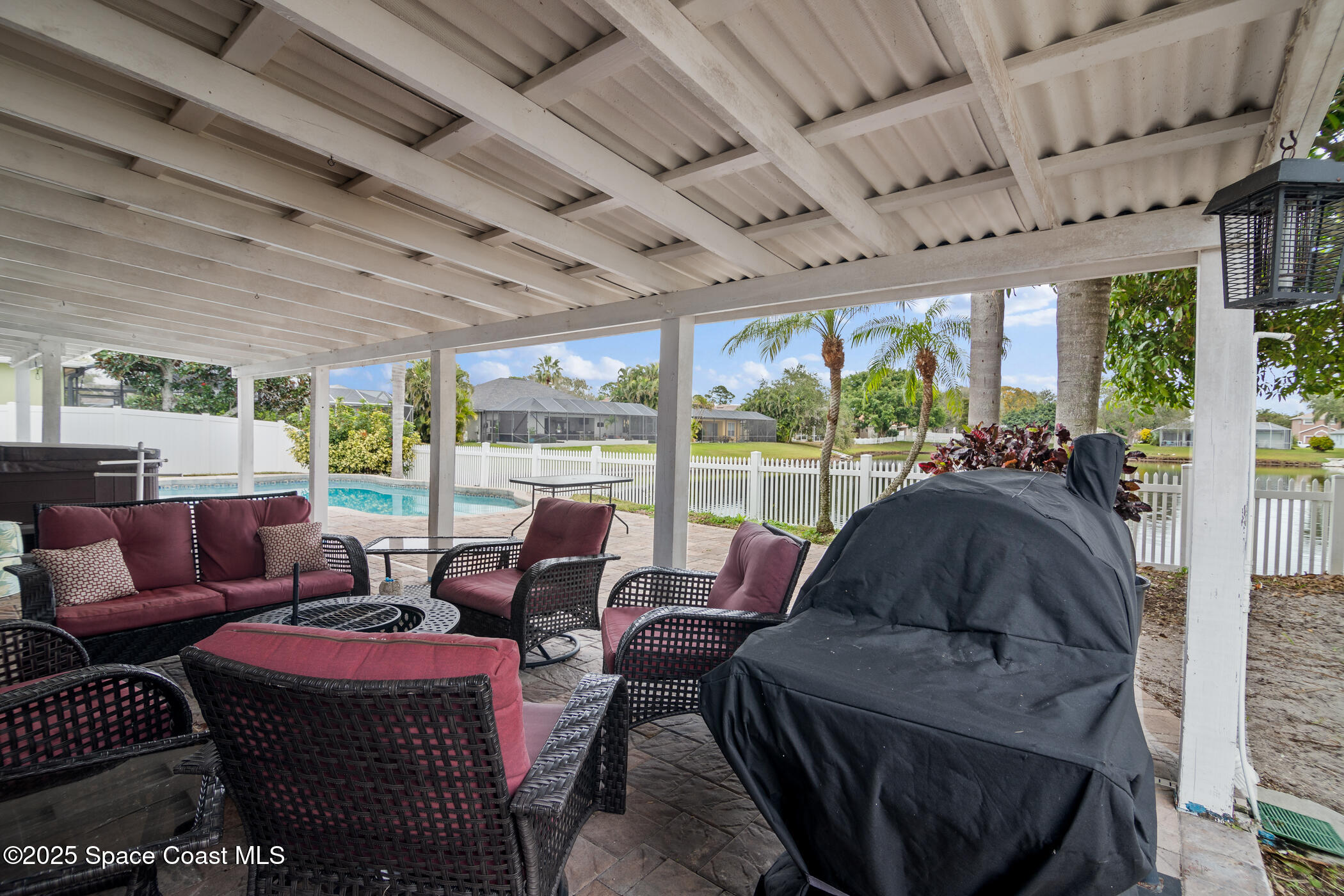 443 Wenthrop Circle Rockledge, FL 32955 - Photo 25 of 38 a living room with furniture a large window with garden view