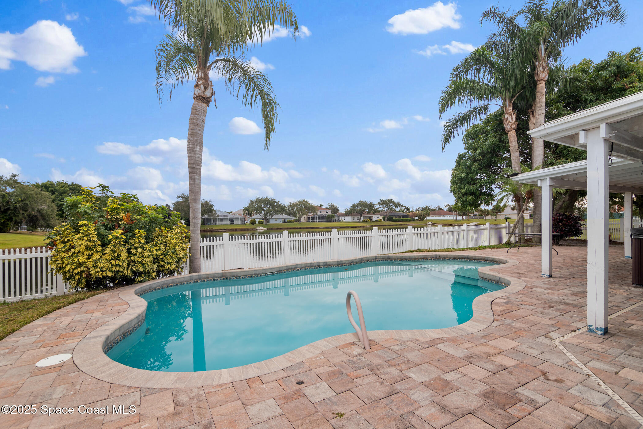443 Wenthrop Circle Rockledge, FL 32955 - Photo 27 of 38 a view of a lake with a yard and potted plants