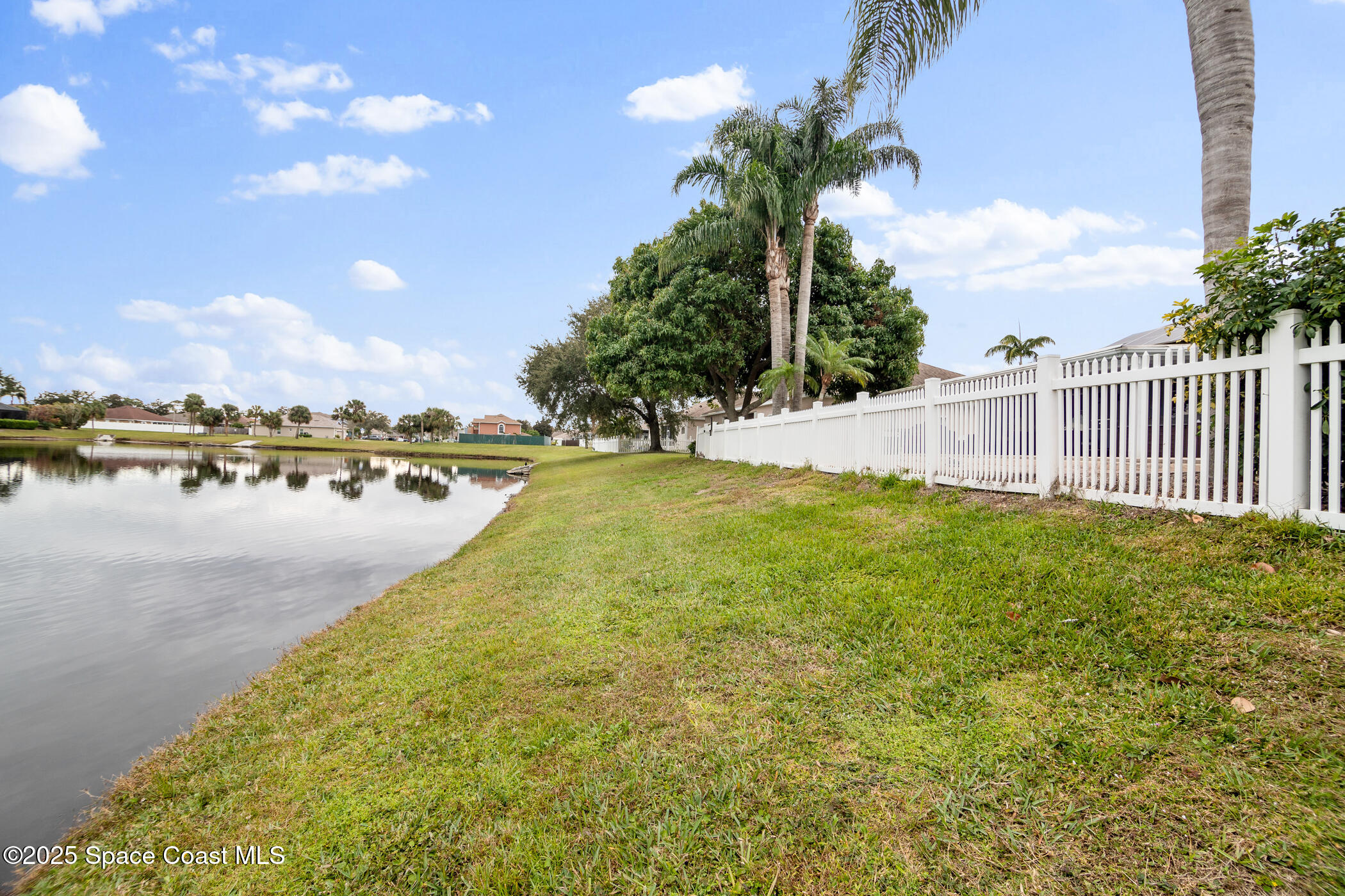 443 Wenthrop Circle Rockledge, FL 32955 - Photo 30 of 38 a view of a lake with houses in the back