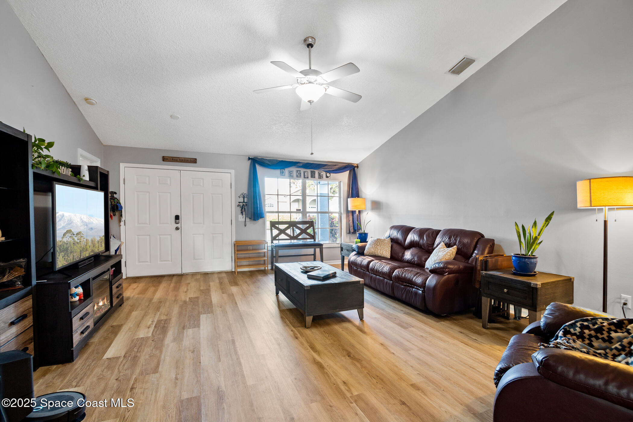 443 Wenthrop Circle Rockledge, FL 32955 - Photo 10 of 38 a living room with furniture and a flat screen tv