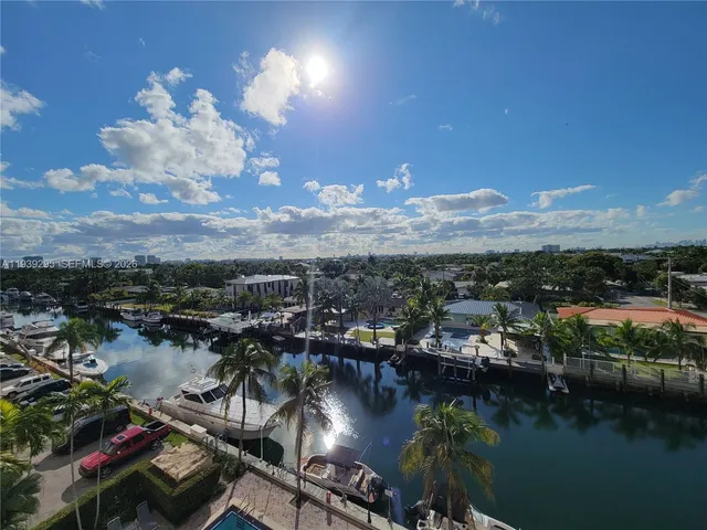 an aerial view of residential houses with outdoor space and river