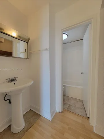 a view of an empty room and wooden floor