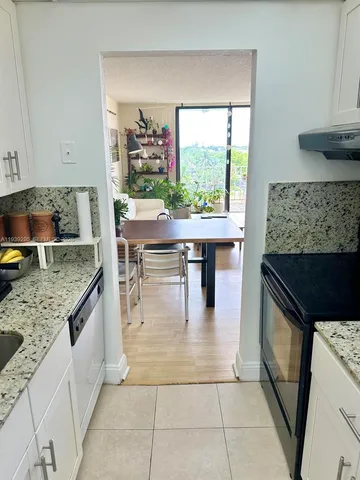 a kitchen with stainless steel appliances granite countertop a stove and a sink