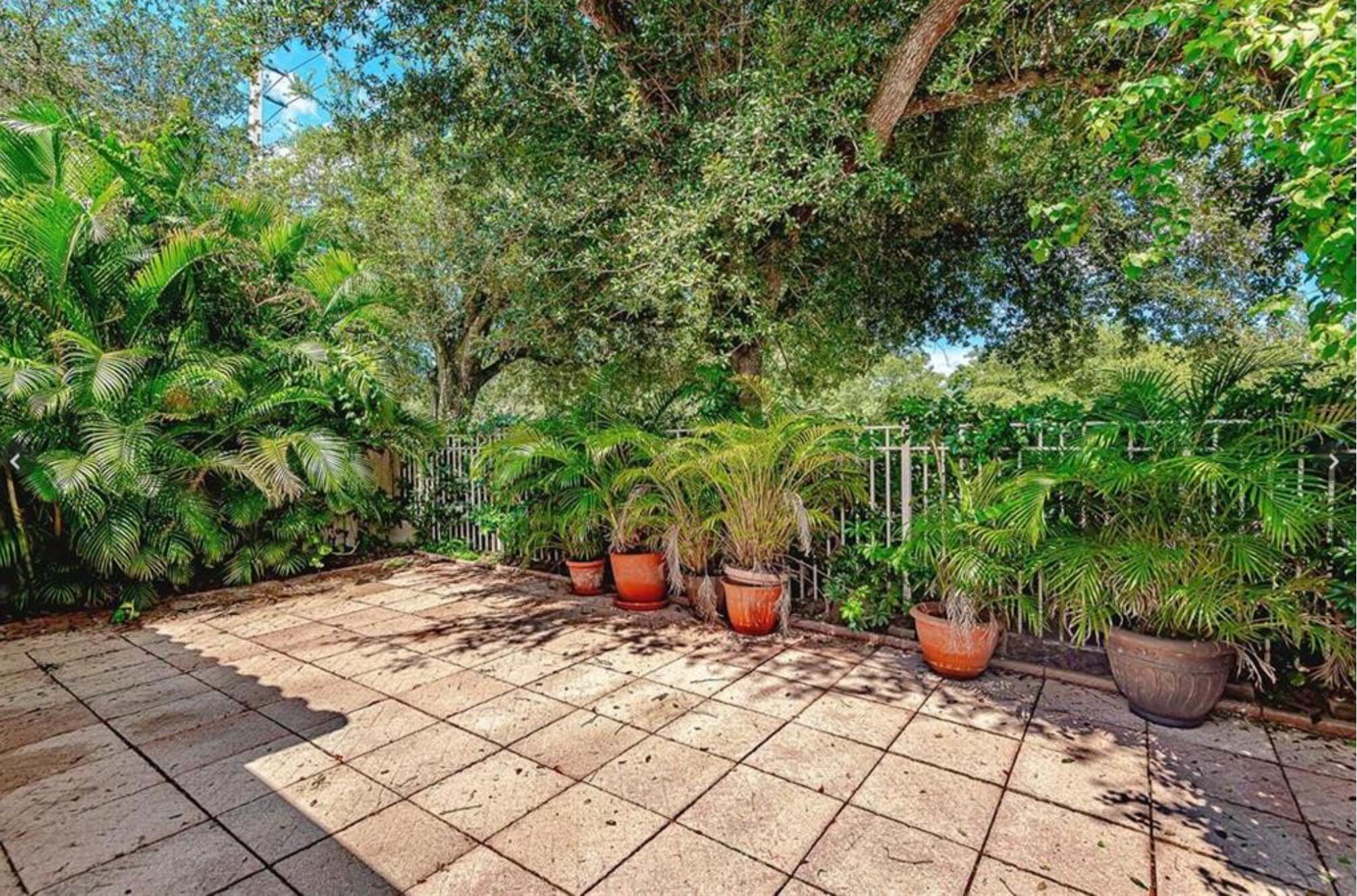 4025 Tree Top Road Cooper City, FL 33026 - Photo 2 of 4 a view of a backyard with potted plants