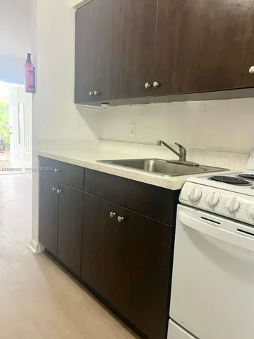 a utility room with sink dryer and washer