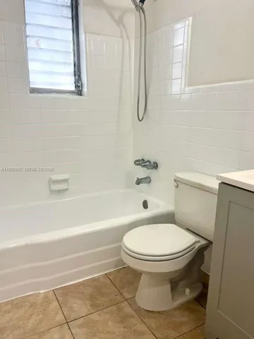 a bathroom with a toilet and a bath tub