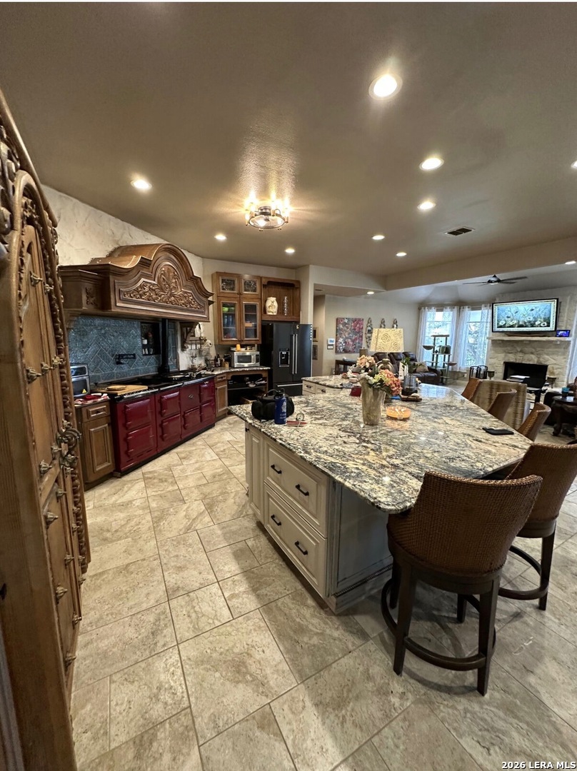 359 Park Ridge Boerne, TX 78006 - Photo 6 of 10 a kitchen with stainless steel appliances kitchen island granite countertop a table chairs sink and cabinets